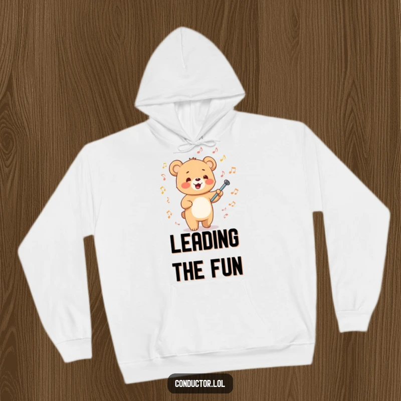 Funny happy cartoon bear cub energetically waving a tiny baton amidst musical notes on a cozy hoodie, warm musical leadership.